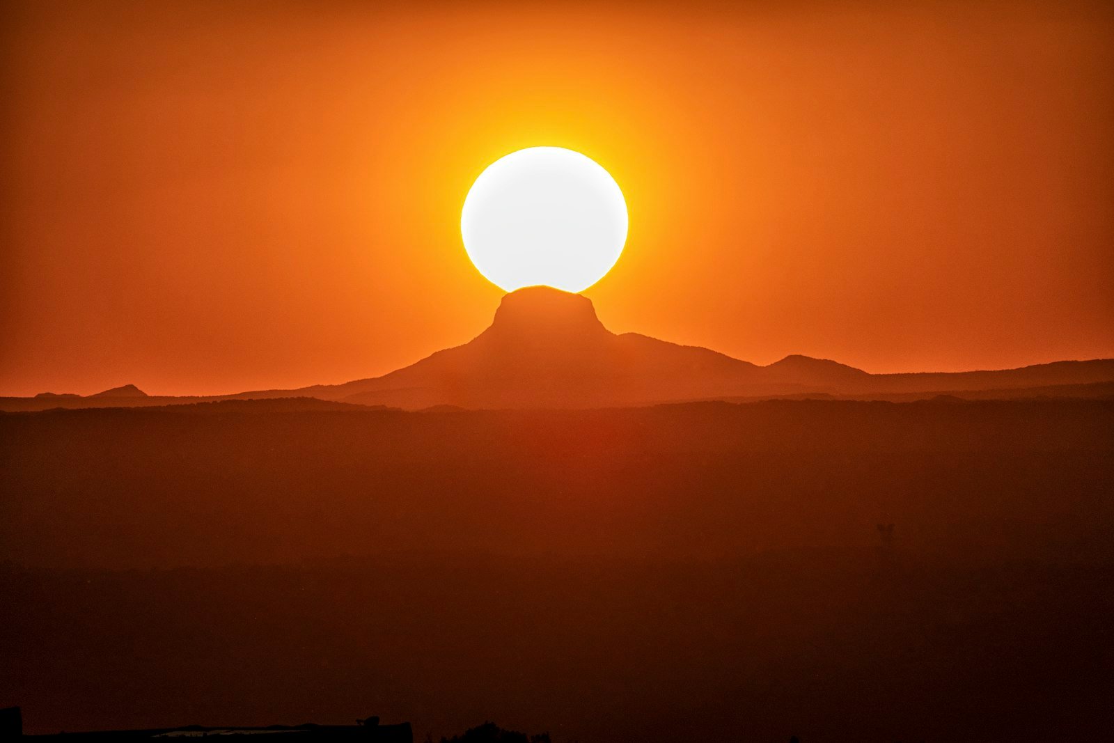 Silhouette of desert mountain range at sunrise