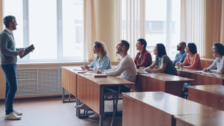 Adult ESL classroom with teacher engaging students in discussion