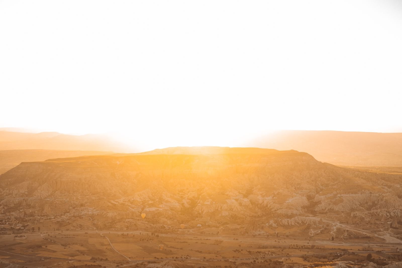 Golden desert sunrise over mountain landscape