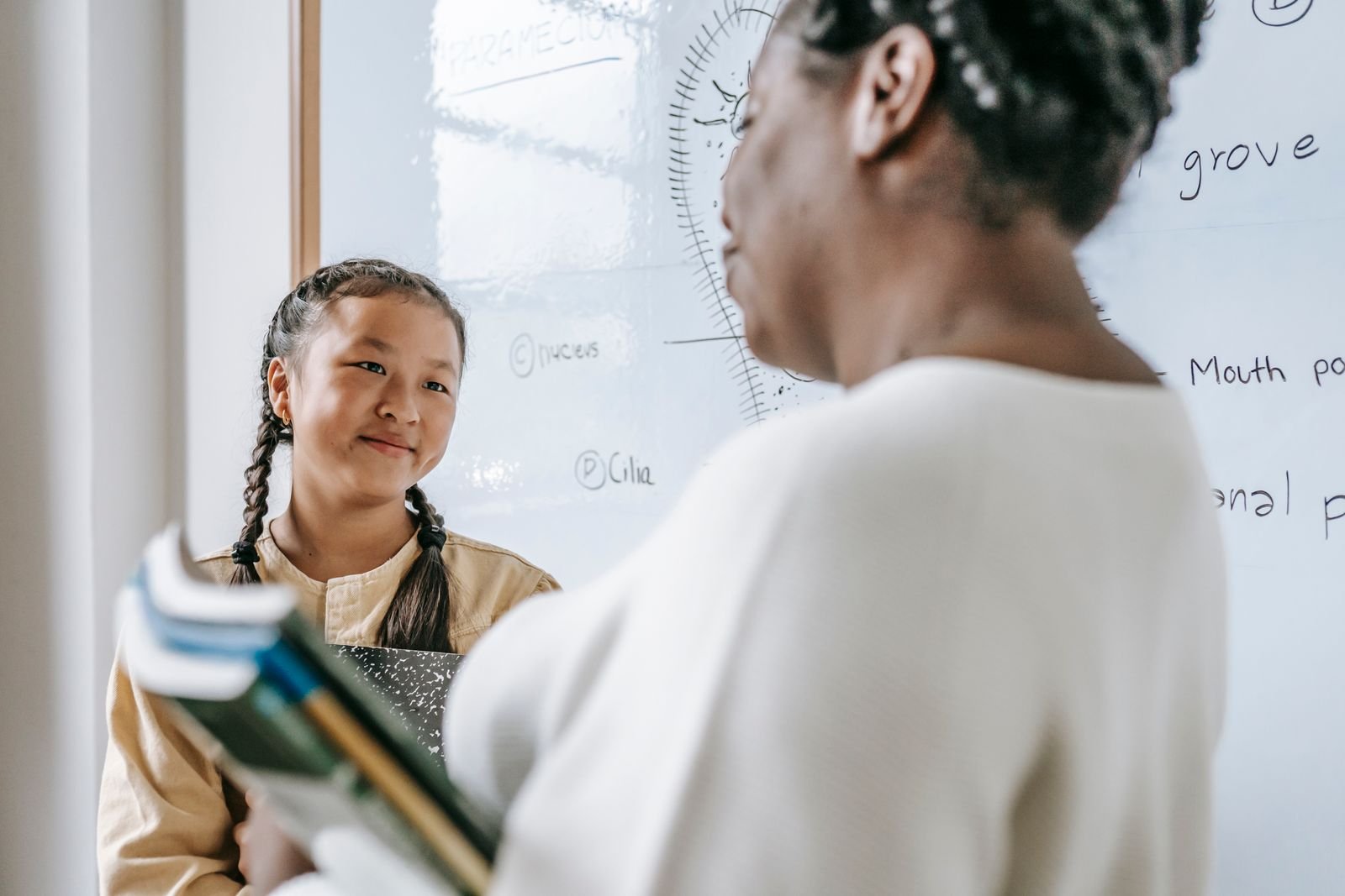 Teacher giving warm feedback to student in conversation